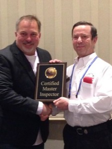 Yuri Olhovsky receives a Certified Master Inspector award from  Executive Director of the Master Inspector Certification Board Nick Gromicko